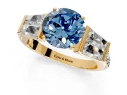 Channel-Set Engagement Ring Setting for Fancy Blue Round Cut Center with Baguette Band and Prong Head in Yellow Gold