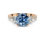 3 Stone Engagement Ring Setting for Fancy Blue Round Cut Center with Round Cut Side Accents and Prong Head in Rose Gold