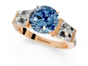 Channel-Set Engagement Ring Setting for Fancy Blue Round Cut Center with Baguette Band and Prong Head in Rose Gold