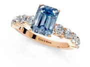 Shared-Prong Engagement Ring Setting for Fancy Blue Emerald Cut Center with Graduated Accents and Prong Head in Rose Gold