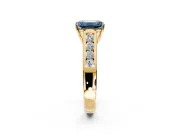 Solitaire Engagement Ring Setting for Fancy Blue Emerald Cut Center with Round Cut Channel Band and Prong Head in Yellow Gold