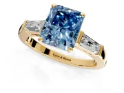 3 Stone Engagement Ring Setting for Fancy Blue Radiant Cut Center with Tapered Baguettes, Plain Band and Prong Head in Yellow Gold