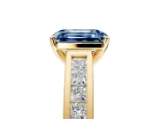 Solitaire Engagement Ring Setting for Fancy Blue Emerald Cut Center with Princess Cut Channel Band and Prong Head in Yellow Gold