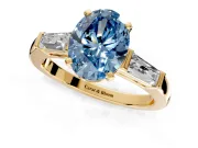 3 Stone Engagement Ring Setting for Fancy Blue Oval Center with Tapered Baguettes, Plain Band and Prong Head in Yellow Gold