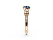 3 Stone Engagement Ring Setting for Fancy Blue Round Cut Center with Crossover Basket, Pave Band and Prong Head in Rose Gold