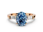 3 Stone Engagement Ring Setting for Fancy Blue Oval Center with Channel Baguette Accents and Prong Head in Rose Gold