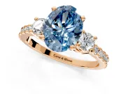 3 Stone Engagement Ring Setting for Fancy Blue Oval Center with Round Cut Side Accents and Prong Head in Rose Gold