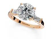3 Stone Engagement Ring Setting for Round Cut Center with Channel Baguette Accents and Prong Head in Rose Gold