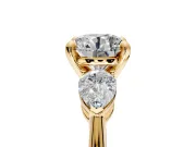 3 Stone Engagement Ring Setting for Round Cut Center with Large Pear-Shaped Accents and Prong Head in Yellow Gold