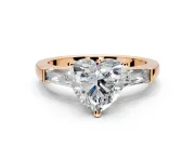 3 Stone Engagement Ring Setting for Heart-Shaped Center with Tapered Baguettes, Plain Band and Prong Head in Rose Gold