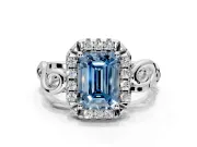Halo Engagement Ring Setting for Fancy Blue Emerald Cut Center with Open Scroll Shoulders and Prong Head in Platinum