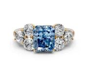 Cluster Engagement Ring Setting for Fancy Blue Radiant Cut Center with Round Cut Accent Frame and Prong Head in Yellow Gold