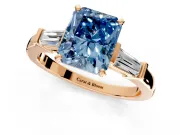 3 Stone Engagement Ring Setting for Fancy Blue Radiant Cut Center with Channel Baguette Accents and Prong Head in Rose Gold
