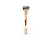 3 Stone Engagement Ring Setting for Fancy Blue Cushion Cut Center with Channel Baguette Accents and Prong Head in Rose Gold