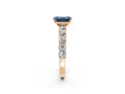 Shared-Prong Engagement Ring Setting for Fancy Blue Emerald Cut Center with Graduated Accents and Prong Head in Rose Gold