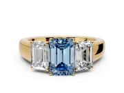 3 Stone Engagement Ring Setting for Fancy Blue Emerald Cut Center with Raised Basket Heads and Prong Head in Yellow Gold