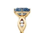 Solitaire Engagement Ring Setting for Fancy Blue Emerald Cut Center with Accented Twist Band and Leaf Prong Head in Yellow Gold