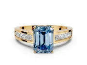 Solitaire Engagement Ring Setting for Fancy Blue Emerald Cut Center with Princess Cut Channel Band and Prong Head in Yellow Gold