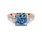 3 Stone Engagement Ring Setting for Fancy Blue Princess Cut Center with Round Cut Side Accents and Prong Head in Rose Gold