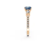 3 Stone Engagement Ring Setting for Fancy Blue Cushion Cut Center with Round Cut Side Accents and Prong Head in Rose Gold