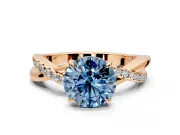 Crossover Engagement Ring Setting for Fancy Blue Round Cut Center with Pave and Plain Strands and Prong Head in Rose Gold