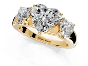 3 Stone Engagement Ring Setting for Heart-Shaped Center with Raised Basket Heads and Prong Head in Yellow Gold