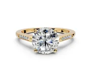 Solitaire Engagement Ring Setting for Round Cut Center with Channel Accents and Prong Head in Yellow Gold