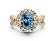 Halo Engagement Ring Setting for Fancy Blue Oval Center with Pave Infinity Twist Band and Prong Head in Yellow Gold