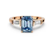 3 Stone Engagement Ring Setting for Fancy Blue Emerald Cut Center with Channel Baguette Accents and Prong Head in Rose Gold