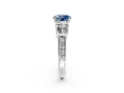 Channel-Set Engagement Ring Setting for Fancy Blue Round Cut Center with Baguette Band and Prong Head in Platinum