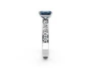 Solitaire Engagement Ring Setting for Fancy Blue Emerald Cut Center with Channel-Set Accents and Prong Head in Platinum