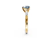 3 Stone Engagement Ring Setting for Fancy Blue Heart-Shaped Center with Tapered Baguettes, Plain Band and Prong Head in Yellow Gold
