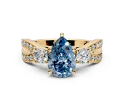 3 Stone Engagement Ring Setting for Fancy Blue Pear-Shaped Center with Pave Twist Band and Prong Head in Yellow Gold
