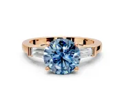 3 Stone Engagement Ring Setting for Fancy Blue Round Cut Center with Channel Baguette Accents and Prong Head in Rose Gold
