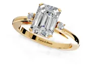 3 Stone Engagement Ring Setting for Emerald Cut Center with Low-Set Round Cut Accents and Prong Head in Yellow Gold