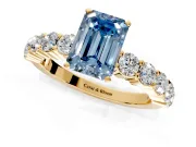 Shared-Prong Engagement Ring Setting for Fancy Blue Emerald Cut Center with Graduated Accents and Prong Head in Yellow Gold