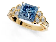 Cluster Engagement Ring Setting for Fancy Blue Princess Cut Center with Bezel Accent Clusters and Prong Head in Yellow Gold