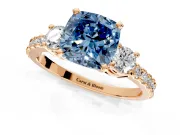 3 Stone Engagement Ring Setting for Fancy Blue Cushion Cut Center with Round Cut Side Accents and Prong Head in Rose Gold