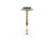Halo Engagement Ring Setting for Fancy Blue Emerald Cut Center with Narrowing Pave Band and Prong Head in Yellow Gold