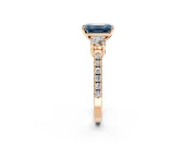 3 Stone Engagement Ring Setting for Fancy Blue Emerald Cut Center with Round Cut Side Accents and Prong Head in Rose Gold