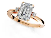 3 Stone Engagement Ring Setting for Emerald Cut Center with Low-Set Round Cut Accents and Prong Head in Rose Gold