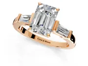 3 Stone Engagement Ring Setting for Emerald Cut Center with Channel Baguette Accents and Prong Head in Rose Gold