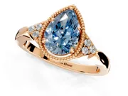 Cluster Engagement Ring Setting for Fancy Blue Pear-Shaped Center with Milgrain Shoulder Clusters and Prong Head in Rose Gold