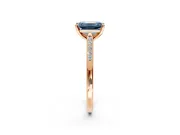 Solitaire Engagement Ring Setting for Fancy Blue Emerald Cut Center with Channel Accents and Prong Head in Rose Gold