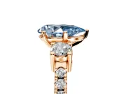 3 Stone Engagement Ring Setting for Fancy Blue Pear-Shaped Center with Round Cut Side Accents and Prong Head in Rose Gold