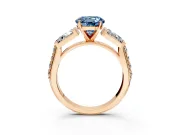 Channel-Set Engagement Ring Setting for Fancy Blue Round Cut Center with Baguette Band and Prong Head in Rose Gold