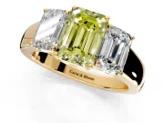 3 Stone Engagement Ring Setting for Fancy Yellow Emerald Cut Center with Raised Basket Heads and Prong Head in Yellow Gold