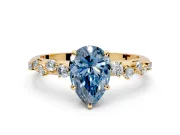 Cluster Engagement Ring Setting for Fancy Blue Pear-Shaped Center with Round Cut Accent Band and Prong Head in Yellow Gold