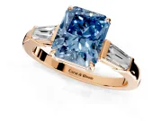 3 Stone Engagement Ring Setting for Fancy Blue Radiant Cut Center with Baguette Accents and Prong Head in Rose Gold