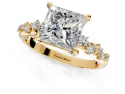 Solitaire Engagement Ring Setting for Princess Cut Center with Trailing Leaf Accent Band and Prong Head in Yellow Gold